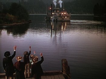 Movie still from “The Yearling” (1946), directed by Clarence Brown – A group of people standing on a dock next to a river; Extreme Wide shot, High angle