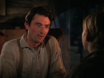 Movie still from “The Yearling” (1946), directed by Clarence Brown – A man sitting in front of another man in a chair; Close Up shot, Over the shoulder angle
