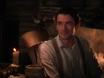 Movie still from “The Yearling” (1946), directed by Clarence Brown – A man sitting in a chair in front of a candle; Close Up shot, Over the shoulder angle