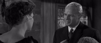 Movie still from “The Young Lions” (1958), directed by Edward Dmytryk – A man and a woman talking to each other; Close Up shot, Over the shoulder angle