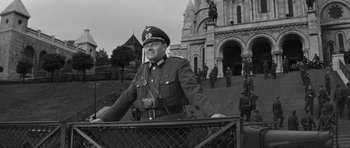 Movie still from “The Young Lions” (1958), directed by Edward Dmytryk – An old photo of a man in a military uniform; Medium shot, Low angle