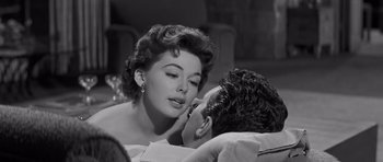 Movie still from “The Young Lions” (1958), directed by Edward Dmytryk – An old black and white photo of a man and a woman kissing; Close Up shot, Low angle