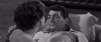 Movie still from “The Young Lions” (1958), directed by Edward Dmytryk – A man and a woman sitting in a chair; Close Up shot, Over the shoulder angle