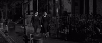 Movie still from “The Young Lions” (1958), directed by Edward Dmytryk – A man and a woman walking down a street; Wide shot, Low angle