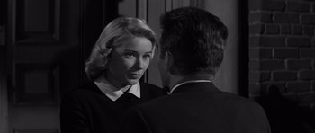 Movie still from “The Young Lions” (1958), directed by Edward Dmytryk – A man and a woman looking at one another in a mirror; Close Up shot, Over the shoulder angle