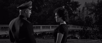 Movie still from “The Young Lions” (1958), directed by Edward Dmytryk – A man and a woman talking to each other; Medium shot, Low angle