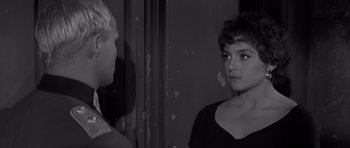 Movie still from “The Young Lions” (1958), directed by Edward Dmytryk – A black - and - white photo of a woman and a man; Close Up shot, Over the shoulder angle