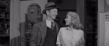 Movie still from “The Young Lions” (1958), directed by Edward Dmytryk – An old photo of a man and a woman smiling; Medium shot, Low angle