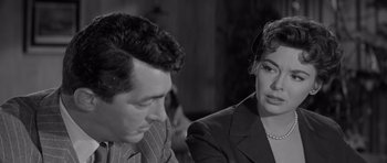 Movie still from “The Young Lions” (1958), directed by Edward Dmytryk – A man and a woman sitting next to each other; Close Up shot, Over the shoulder angle