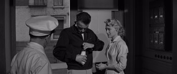 Movie still from “The Young Lions” (1958), directed by Edward Dmytryk – A man and a woman standing next to each other; Medium shot, Low angle