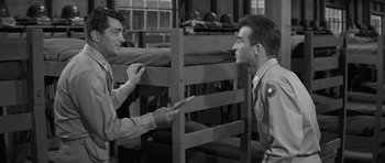 Movie still from “The Young Lions” (1958), directed by Edward Dmytryk – Two men in uniforms are looking at each other; Medium shot, High angle