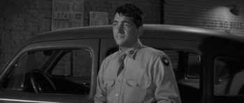 Movie still from “The Young Lions” (1958), directed by Edward Dmytryk – Black and white photograph of a man in a uniform; Close Up shot, Low angle