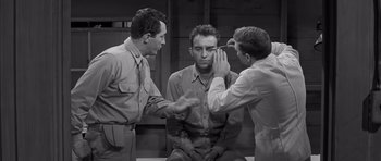 Movie still from “The Young Lions” (1958), directed by Edward Dmytryk – A group of men standing next to each other; Medium shot, Over the shoulder angle