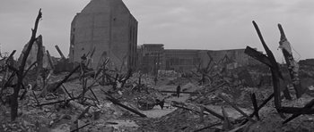 Movie still from “The Young Lions” (1958), directed by Edward Dmytryk – A black - and - white photo of a destroyed building; Extreme Wide shot, High angle