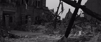 Movie still from “The Young Lions” (1958), directed by Edward Dmytryk – A black - and - white photo of a destroyed building; Wide shot, Low angle