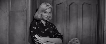 Movie still from “The Young Lions” (1958), directed by Edward Dmytryk – A black and white photo of a woman holding a nintendo wii game controller; Close Up shot, Low angle