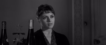 Movie still from “The Young Lions” (1958), directed by Edward Dmytryk – A black - and - white photo of a woman in a black jacket; Close Up shot, Low angle