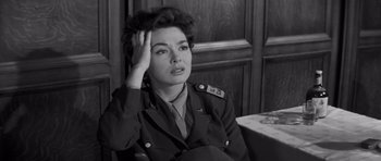 Movie still from “The Young Lions” (1958), directed by Edward Dmytryk – An old photo of a woman in a military uniform; Close Up shot, High angle