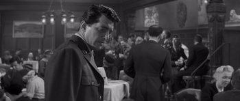 Movie still from “The Young Lions” (1958), directed by Edward Dmytryk – Black and white photograph of a man in a military uniform; Medium shot, Over the shoulder angle