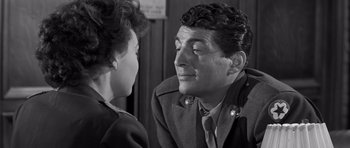 Movie still from “The Young Lions” (1958), directed by Edward Dmytryk – An old photo of a man and a young woman looking at each other; Close Up shot, Over the shoulder angle