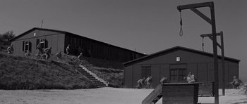 Movie still from “The Young Lions” (1958), directed by Edward Dmytryk – A black and white photo of people climbing stairs; Extreme Wide shot, Low angle
