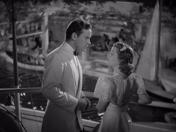 Movie still from “The Young in Heart” (1938), directed by Gilbert Pratt – A man and a woman standing next to each other; Medium shot, High angle