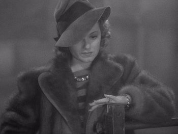 Movie still from “The Young in Heart” (1938), directed by Gilbert Pratt – An old photo of a woman wearing a hat and a fur coat; Close Up shot, High angle
