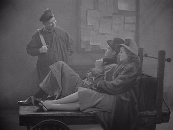 Movie still from “The Young in Heart” (1938), directed by Gilbert Pratt – An old photo of a man and a woman sitting on a bench; Wide shot, High angle
