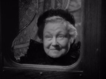 Movie still from “The Young in Heart” (1938), directed by Gilbert Pratt – An older woman looking in a mirror; Close Up shot, High angle