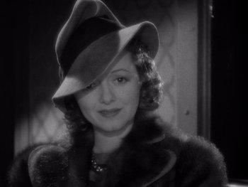 Movie still from “The Young in Heart” (1938), directed by Gilbert Pratt – An old photo of a woman wearing a hat; Close Up shot, High angle