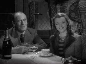 Movie still from “The Young in Heart” (1938), directed by Gilbert Pratt – An older man and woman sitting at a dinner table; Medium shot, High angle