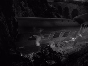 Movie still from “The Young in Heart” (1938), directed by Gilbert Pratt – A black and white photo of a train on the tracks; Extreme Wide shot, High angle