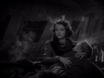 Movie still from “The Young in Heart” (1938), directed by Gilbert Pratt – An old photo of a woman holding a child; Medium shot, High angle