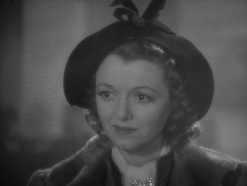 Movie still from “The Young in Heart” (1938), directed by Gilbert Pratt – An old photo of a woman wearing a hat; Close Up shot, High angle