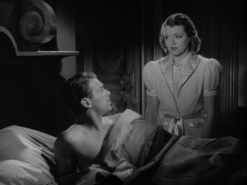 Movie still from “The Young in Heart” (1938), directed by Gilbert Pratt – A man and a woman are in a bedroom; Medium shot, Low angle