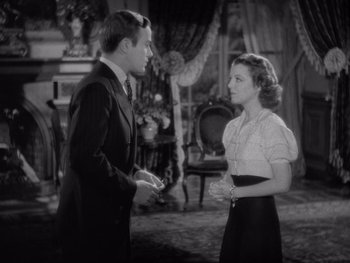 Movie still from “The Young in Heart” (1938), directed by Gilbert Pratt – A man and a woman talking in front of each other; Medium shot, High angle