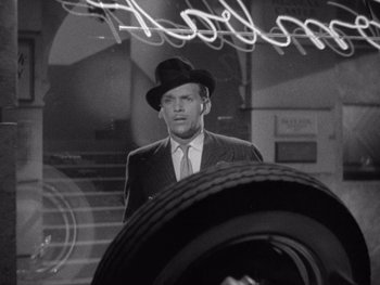 Movie still from “The Young in Heart” (1938), directed by Gilbert Pratt – A black and white photo of a man in a suit and hat; Close Up shot, Low angle