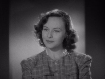 Movie still from “The Young in Heart” (1938), directed by Gilbert Pratt – An old photo of an older woman in a plaid jacket; Close Up shot, High angle