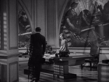 Movie still from “The Young in Heart” (1938), directed by Gilbert Pratt – A man and a woman standing in front of a painting; Wide shot, High angle