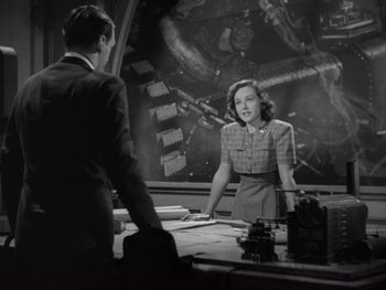 Movie still from “The Young in Heart” (1938), directed by Gilbert Pratt – A man and a woman in front of a painting; Medium shot, High angle