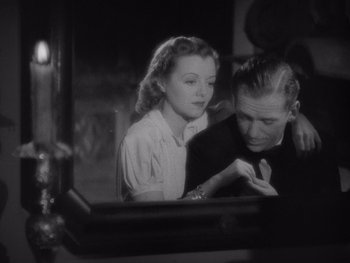 Movie still from “The Young in Heart” (1938), directed by Gilbert Pratt – A man and a woman looking in a mirror; Medium shot, High angle