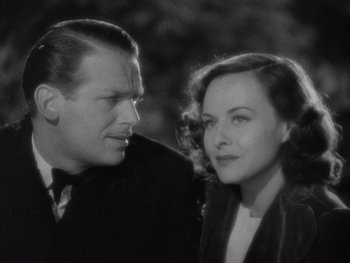 Movie still from “The Young in Heart” (1938), directed by Gilbert Pratt – A man and a woman standing next to each other; Close Up shot, High angle