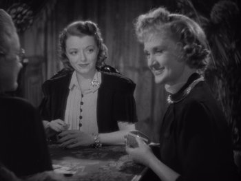 Movie still from “The Young in Heart” (1938), directed by Gilbert Pratt – Two women sitting at a table in front of each other; Medium shot, High angle