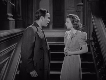 Movie still from “The Young in Heart” (1938), directed by Gilbert Pratt – A man and a woman standing next to each other on steps; Medium shot, High angle