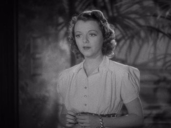 Movie still from “The Young in Heart” (1938), directed by Gilbert Pratt – An old black and white photo of a young woman; Close Up shot, High angle