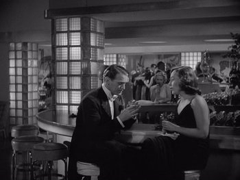 Movie still from “The Young in Heart” (1938), directed by Gilbert Pratt – A man and a woman sitting at a bar; Medium shot, High angle
