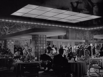 Movie still from “The Young in Heart” (1938), directed by Gilbert Pratt – A black and white photo of people in a restaurant; Extreme Wide shot, Low angle