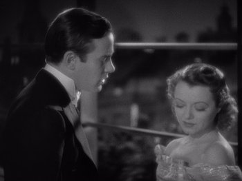Movie still from “The Young in Heart” (1938), directed by Gilbert Pratt – A man and a woman standing next to each other; Close Up shot, High angle