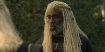 Movie still from “House of the Dragon” (2022), created by George R.R. Martin – A man with dreadlocks and a long beard; Close Up shot, Over the shoulder angle