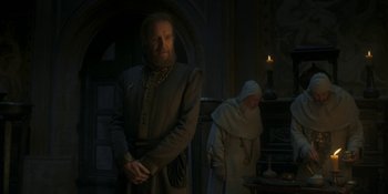 Movie still from “House of the Dragon” (2022), created by George R.R. Martin – A man and a woman standing next to each other in a room; Medium shot, Low angle